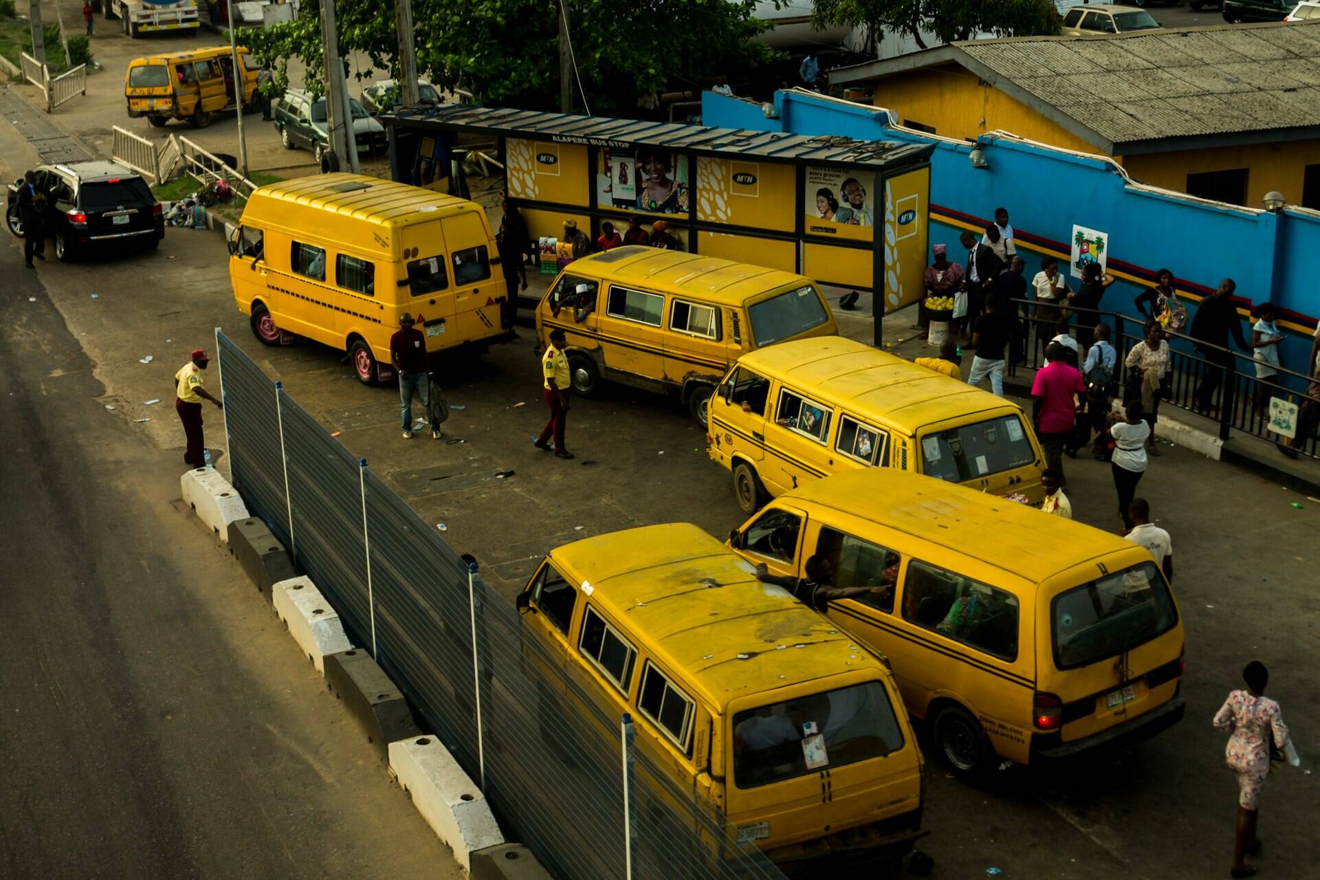 Bustling street scene with danfo minibuses in Lagos, Nigeria